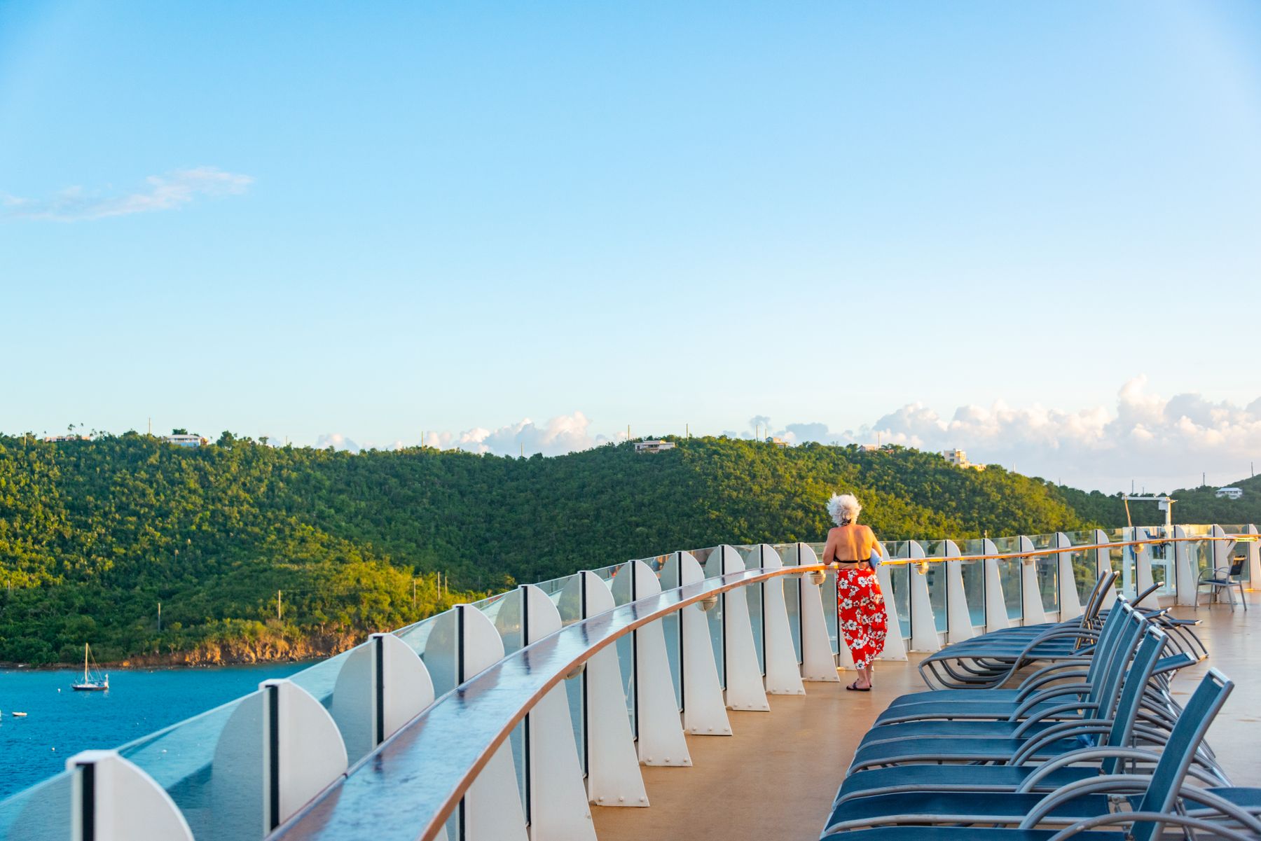 A woman enjoying the view from the deck of a cruise ship