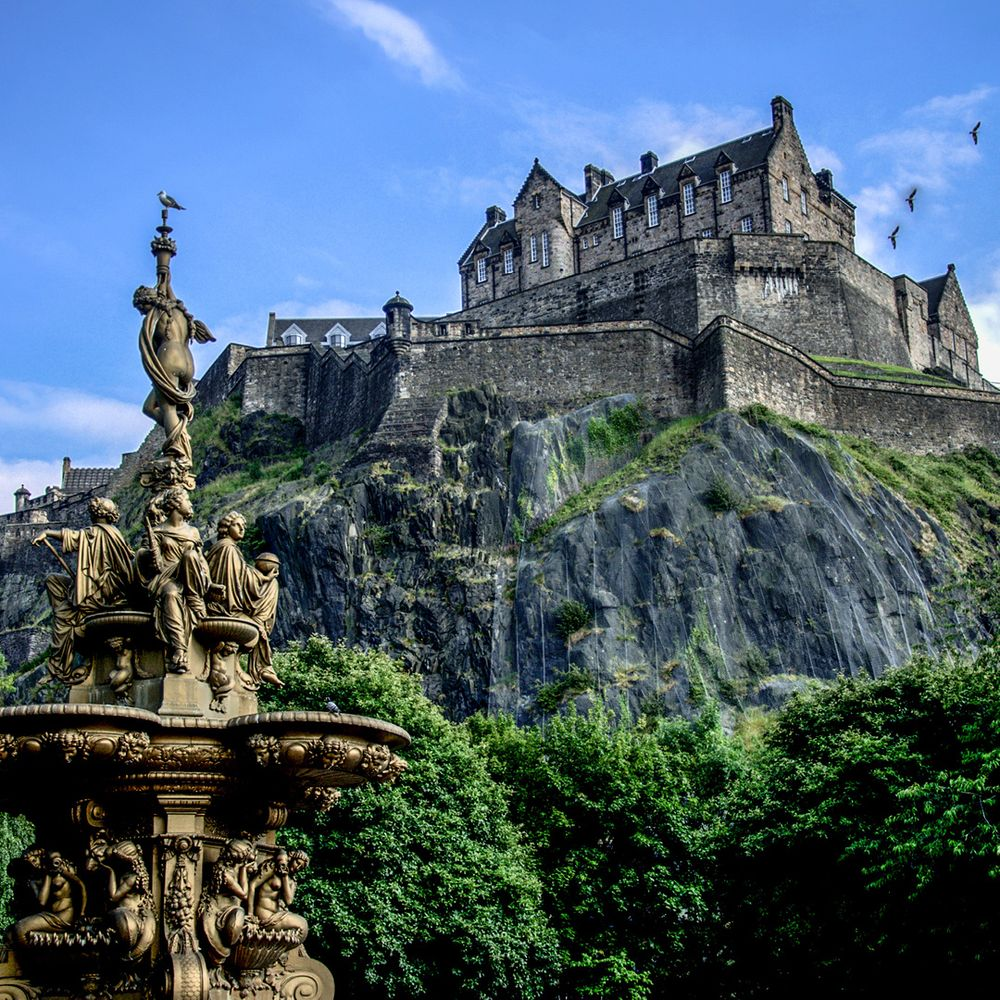 Edinburgh Castle above the Ross Fountain in Princes Street Gardens, Scotland.